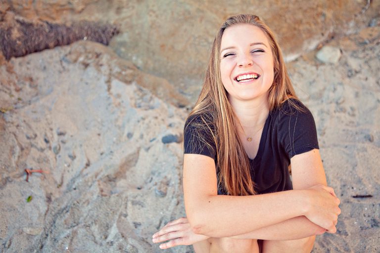 A happy Carlsbad orthodontic patient smiling outdoors