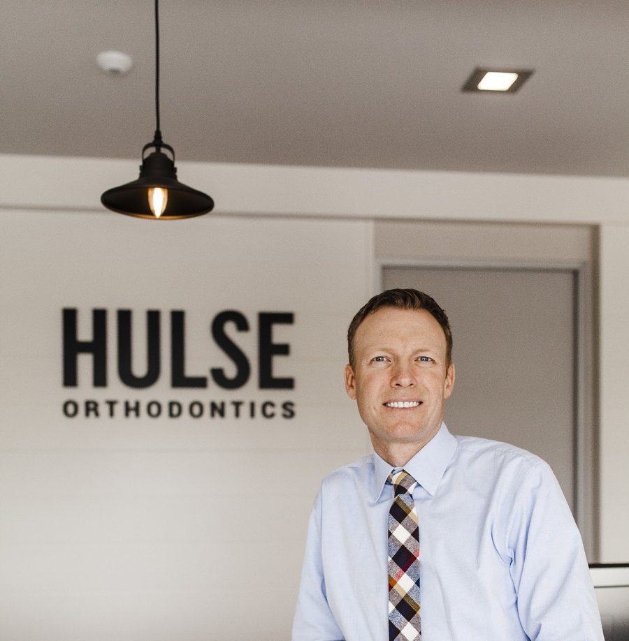 Dr. Cameron Hulse, specialist orthodontist, at the Hulse Orthodontics front desk in Carlsbad